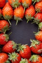 Strawberry on dark background with selective focus and crop fragment