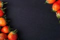 Strawberry on dark background with selective focus and crop fragment