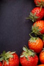 Strawberry on dark background with selective focus and crop fragment