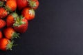 Strawberry on dark background with selective focus and crop fragment