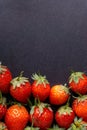 Strawberry on dark background with selective focus and crop fragment Royalty Free Stock Photo