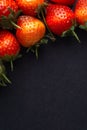 Strawberry on dark background with selective focus and crop fragment