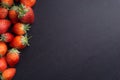 Strawberry on dark background with selective focus and crop fragment