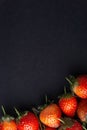 Strawberry on dark background with selective focus and crop fragment Royalty Free Stock Photo