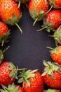 Strawberry on dark background with selective focus and crop fragment