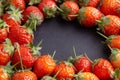 Strawberry on dark background with selective focus and crop fragment