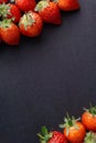 Strawberry on dark background with selective focus and crop fragment