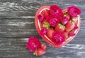 Strawberry dish heart, flower rose festive design dessert on colored wooden background