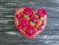 Strawberry dish heart, flower rose summer celebrate greeting festive design dessert on colored wooden background