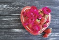 Strawberry dish heart, flower rose summer greeting festive design dessert on colored wooden background