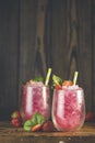 Strawberry drink with ice. Two glass of strawberry ice drink with ripe berry on wooden turquoise table surface