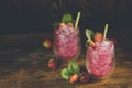 Strawberry drink with ice. Two glass of strawberry ice drink with ripe berry on wooden turquoise table surface