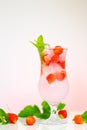 Strawberry drink. summer cocktail.Summer drink.mineral water glass with ice and ripe strawberries with leaves on a light Royalty Free Stock Photo