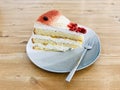 A strawberry frozen yogurt cake in a plate on wooden table. Royalty Free Stock Photo