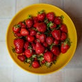 delicious strawberries in a yellow bowl on the table Royalty Free Stock Photo