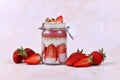 Strawberry fruit smoothie with yogurt, chia seeds and puffed quinoa grains layered in glass