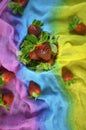 Strawberry fruits on colourful cloth background