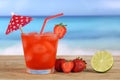 Strawberry fruits juice on the beach and sea