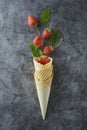 Strawberry fruits in waffle cone, over dark background, top view Royalty Free Stock Photo