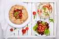 Strawberry galette, summer fruit salad and herb tea. Homemade healthy wholegrain berry open pie. Fruit tart. Top view Royalty Free Stock Photo