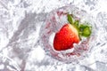 Strawberry in glass on silver reflector stopmotion