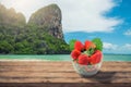 Strawberry Glass on wooden desk and beach side background