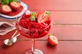 Strawberry granita or fresh berry sorbet in glass on old red wooden table background. Texture of ice cream or sorbet. Ice cream Royalty Free Stock Photo