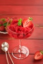 Strawberry granita or fresh berry sorbet in glass on old red wooden table background. Texture of ice cream or sorbet. Ice cream Royalty Free Stock Photo