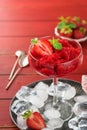 Strawberry granita or fresh berry sorbet in glass on old red wooden table background. Texture of ice cream or sorbet. Ice cream Royalty Free Stock Photo