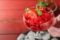 Strawberry granita or fresh berry sorbet in glass on old red wooden table background. Texture of ice cream or sorbet. Ice cream Royalty Free Stock Photo