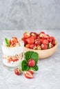 Strawberry granola or smoothie in glass and fresh berries in a wooden bowl. Healthy breakfast Royalty Free Stock Photo