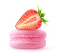 Strawberry half on top of pink macaron isolated on white