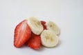 strawberry halves and banana slices isolated on white background Royalty Free Stock Photo