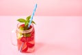 Strawberry homemade lemonade in a mason jar with copy space on pink background. Royalty Free Stock Photo