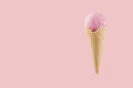 Strawberry ice cream in crisp waffle cone on pastel pink background, mock up for design, summer food. Royalty Free Stock Photo