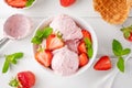 Strawberry ice cream with fresh berries in a bowl on a white wooden background. Selective focus Royalty Free Stock Photo