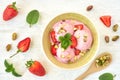 Strawberry ice cream , frozen yogurt with fresh strawberries and mint leaves. Top view
