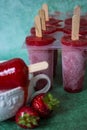 Strawberry ice cream popsicles melting. Healthy dessert. Homemade product. Summer background Royalty Free Stock Photo