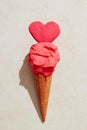 Strawberry ice cream with waffle cone melting on the ground in love heart shape Royalty Free Stock Photo