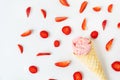 Strawberry ice cream in a waffle cup in the form of a cone, ice cream lies on a white table along with slices of fresh Royalty Free Stock Photo