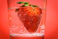 A strawberry immersed in water