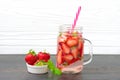 Strawberry infused water, cocktail, lemonade or tea. Summer iced cold drink with strawberry, leaf of mint, ice cube on white Royalty Free Stock Photo