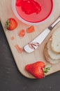 Strawberry jam. Bread and strawberry jam on a dark stone background with jar of jam and fresh strawberry. Top view. Making Royalty Free Stock Photo