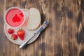 Strawberry jam. Bread and strawberry jam on a wooden table with jar of jam and fresh strawberry. Top view, copyspace. Making Royalty Free Stock Photo