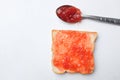 strawberry jam, fresh red berries in a spoon spread slice of bread isolate on a white backdrop