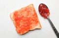 strawberry jam, fresh red berries in a spoon spread slice of bread isolate on a white backdrop