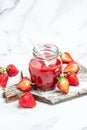 Strawberry jam in the glass jar, Homemade strawberry marmelade and fruits on a light background, vertical image. top view. place