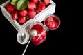 Strawberry jam in a glass jar next to fresh strawberries. On a black wooden background. Homemade winter fruit blanks. Selective Royalty Free Stock Photo