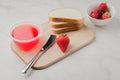 Strawberry jam. Making sandwiches with strawberry jam. Bread and strawberry jam on a white table with jar of jam and fresh Royalty Free Stock Photo