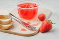 Strawberry jam. Making sandwiches with strawberry jam. Bread and strawberry jam on a white table with jar of jam and fresh Royalty Free Stock Photo